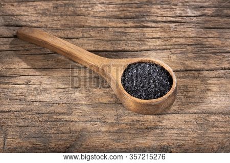 Hawaii Black Salt On Wooden Spoon. Text Space