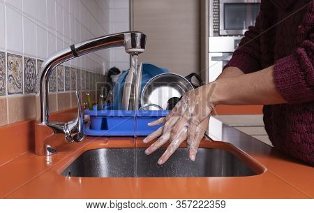 Woman Washing Her Hands In The Kitchen