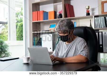 Asian Man Wearing Masks And Working From Home During Covid-19 Quarantine, Concept Of Social Distance