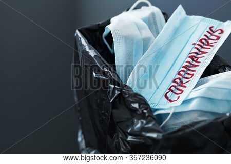 Used Medical Masks Against Coronavirus In Trash Bin. Corona Virus Or Covid-19 Concept.