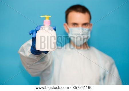 Doctor In Medical Suit Protective Mask And Gloves Washing Hands Before Operating Isolated On Blue Ba