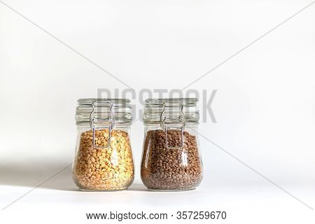 Red Lentils And Yellow Chopped Peas Are Tightly Closed In A Glass Bowl. Legumes Are Stored In Banks.