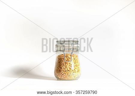 Yellow Chopped Peas Tightly Closed In A Glass Bowl. Legumes Are Stored In Banks. Food Stocks For Fut