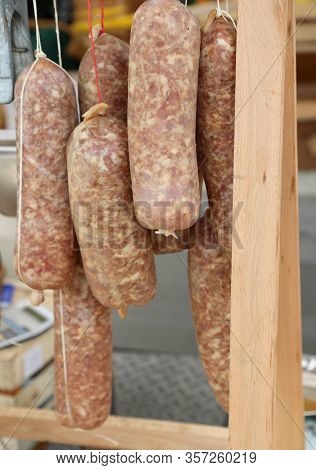 Many Long Pork Sausage For Sale Called Cotechino In Italian Language At Local Market