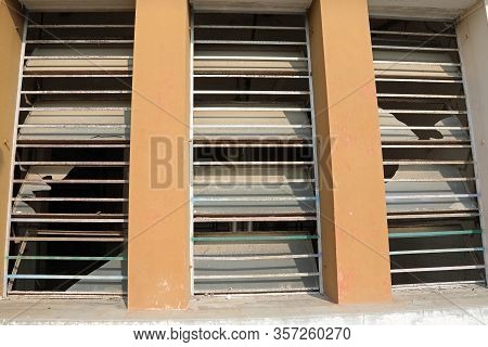 Window With Broken Glass Of An Abandoned Building After Vandalism