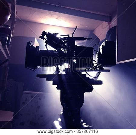 Mystical Silhouette Of A Movie Camera On A Tripod In Standby Mode