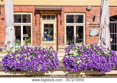 Haapsalu Town, Estonia - July 10, 2018: Beautiful Facade Of The Restaurant Building With Flowers, Hi