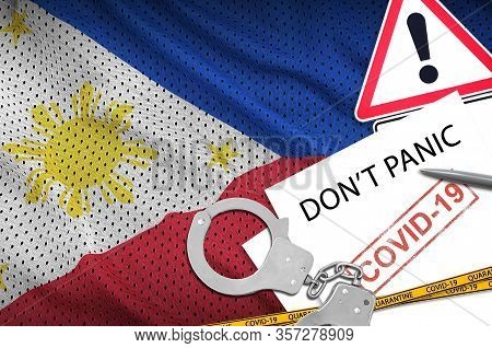 Philippines Flag And Police Handcuffs With Inscription Dont Panic On White Paper. Coronavirus Or 201