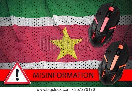 Suriname Flag And Two Computer Mouses. Misinformation During Coronavirus Or 2019-ncov Virus Concept