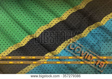 Tanzania Flag And Orange Covid-19 Stamp With Border Tape. Coronavirus Or 2019-ncov Virus Concept