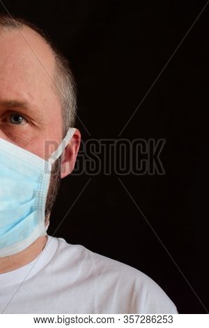 Man In A Medical Mask. Portrait, Close-up. Bokeh. Selective Focus.