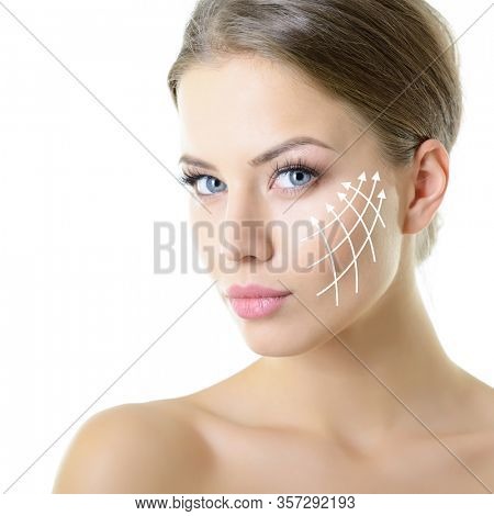 Beauty portrait of young woman with white lines on cheekbones for cosmetic medical procedures or plastic surgery. Skin care, anti-aging, lifting, rejuvenation concept