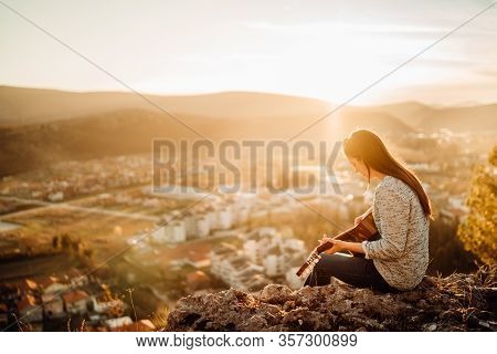 Young Guitarist Playing Acoustic Guitar And Enoying The Sunset.learning To Play An Instrument.singer
