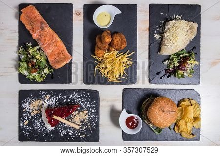 Set With Burger, Croquetes, Crepes, Toast With Salmon And Cheese Cake