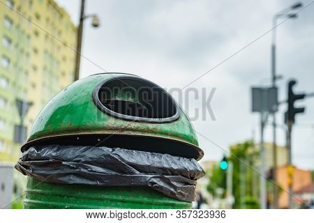 Green Pastic Garbage Bin Or Can On City Street