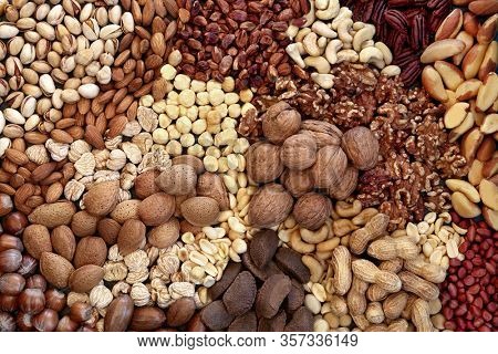 Dried nut collection forming a background. Health food high in protein, omega 3, antioxidants, minerals and vitamins. Can help reduce cholesterol and are beneficial for type 2 diabetes. Flat lay.
