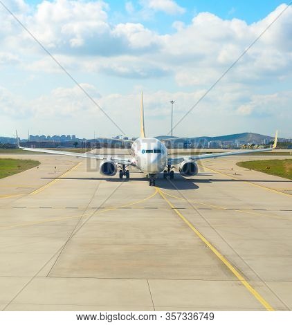 Airplane On Runway At Airport. City In The Background. Turkey