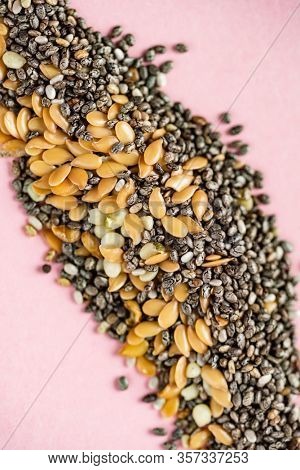 Healthy superfood:  flax seeds, chia seeds and hemp shelled seed on pink background