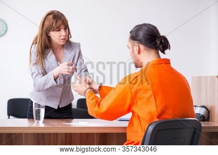 Young man meeting with advocate in pre-trial detention