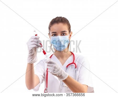Young Woman Doctor In White Uniform, Mask And Gloves With Syringe