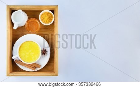 Golden Milk, Turmeric, Honey, Cinnamon And Star Anise On A Wooden Tray On A Grey Background. Masala 