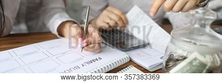 Close-up View Of Couple Calculating Family Budget For New Year. Spouse Accounting Expenses And Plann