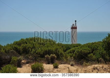 Matalascanas, Spain - July 10, 2011:lighthouse On The Atlantic Ocean In Matalascanas