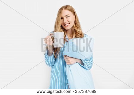 Beautiful Girl In Striped Pajamas, With A Cup In Her Hands , Drinking Coffee Or Tea In The Early Mor