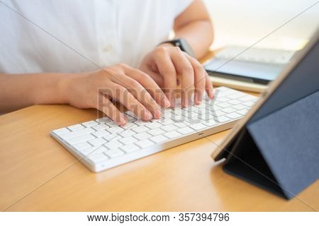 Work From Home Young Freelancer Or Businessman Working At Home Office With Smartphone Tablet. Workin