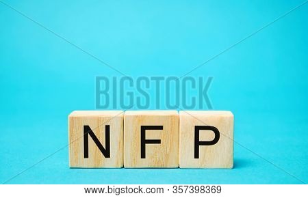 Wooden Blocks With The Word Nfp. Nonfarm Payrolls - Key Economic Indicator. Natural Family Planning 