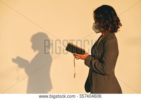 Pray And Bible Concept.asian Female Were Medical Mask Praying,hope For Peace And Free From Disease,h