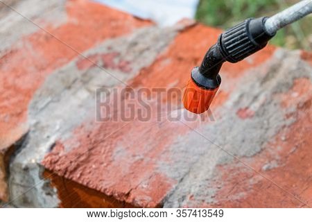 Humidification Of Red Ceramic Brick Masonry Using A Spray Gun Under Pressure. Watering Construction 