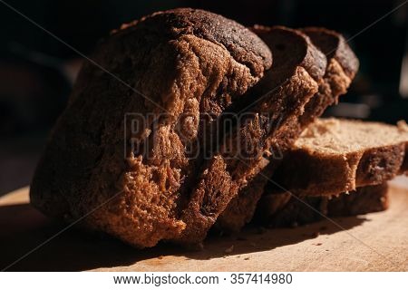 Sliced ​​black Rye Bread On A Wooden Board. Brick-shaped Bread.