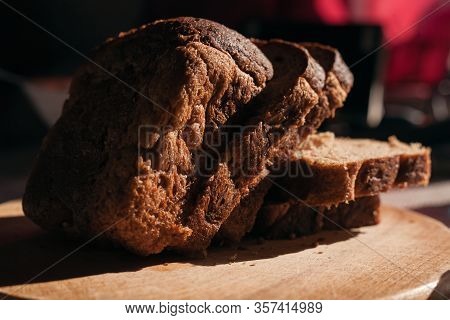 Sliced ​​black Rye Bread On A Wooden Board. Brick-shaped Bread.
