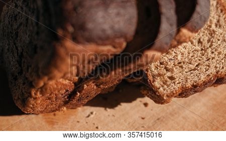 Sliced ​​black Rye Bread On A Wooden Board. Brick-shaped Bread.
