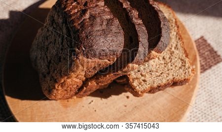 Sliced ​​black Rye Bread On A Wooden Board. Brick-shaped Bread.