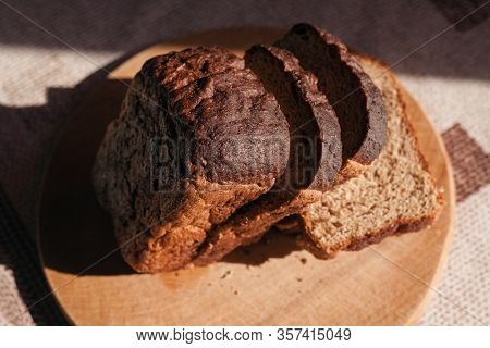 Sliced ​​black Rye Bread On A Wooden Board. Brick-shaped Bread.