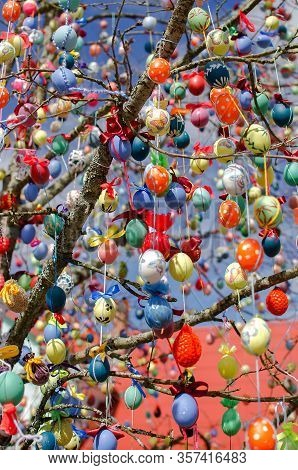 Many Colorful Easter Eggs On The Tree. A Lot Of Easter Eggs Decorated On Tree. Traditional Festive E