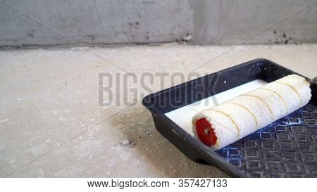 Painting Out A Bare Wall With A Paint Roller With Gray Paint. Hand Painting Using Paint Roller. Pain
