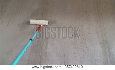 Painting Out A Bare Wall With A Paint Roller With Gray Paint. Hand Painting Using Paint Roller. Pain