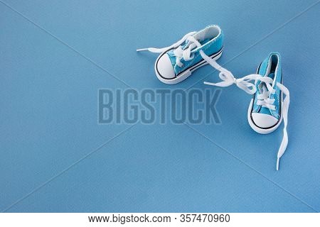 April Fools Day. Surprise Symbol. Shoelaces Tied Together On Blue Wooden Background. April Fool.