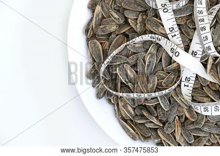 Dry Roasted And Salted Sunflower Seeds On A White Background,