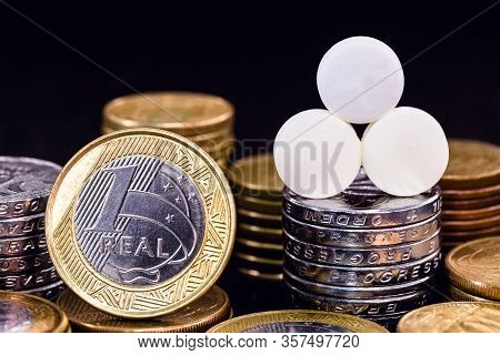 One Real Coin Next To A Pill. Private Or Private Medical Healthcare Concept. Medical Insurance And H