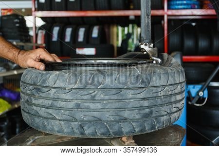 Solve Problem Wheel In Garage Auto Repair Shop Service. Replacement Repairman Fixing Car's Tire Tryi