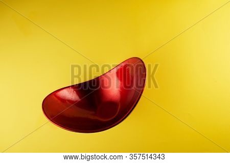 red oval shape oriental container on yeollow background