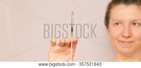 Girl Hold Insulin Injection In Hand. Blurred Face. Anri Virus Vaccine. Woman Nurse Background. Medic