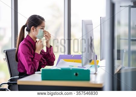 Female Employee Wearing Put On Surgical Hygienic Mask On Her Face For Protect Herself From Dangerous