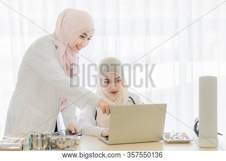 Two Attractive Young Beautiful Female Muslim Doctor Covered Face With Hijab Dress Talking With Famil