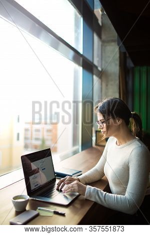 Young Hipster Girl In Fashionable Glasses Experienced Creative Designer Working On Pc Laptop Compute