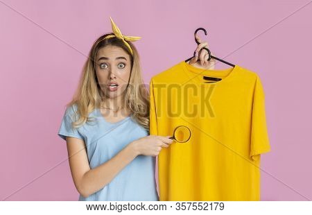 Removing Stains From Clothing Concept. Shocked Housewife With Magnifier, Free Space